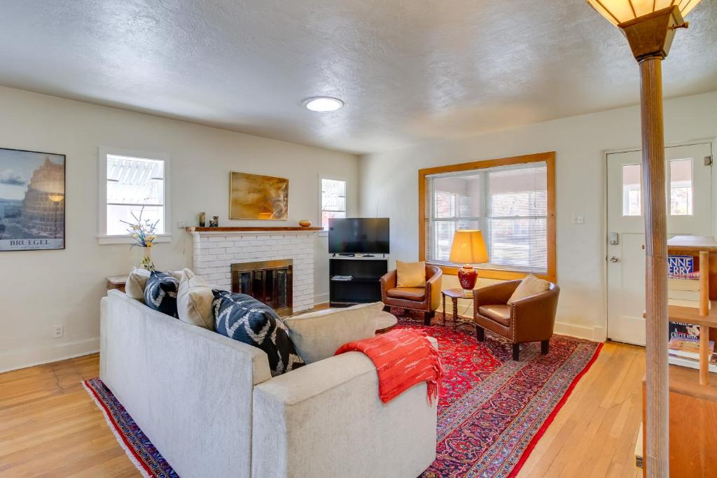 a living room with a couch and a fireplace at Silver Hill Apartment Near UNM Campus! in Albuquerque