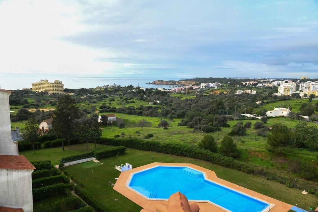 a person pointing at a swimming pool in a yard at Apartment Mar à Vista in Portimão