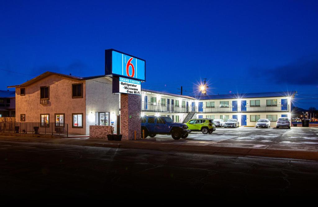 a gas station with a sign in a parking lot at Motel 6 Williams AZ Downtown Grand Canyon in Williams