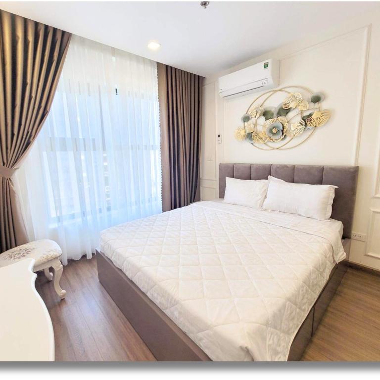 a bedroom with a large bed and a window at FLC Luxury Apartment Quy Nhon in Quy Nhon