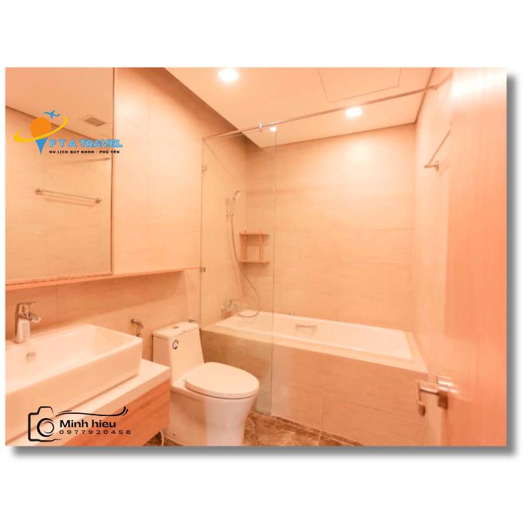 a bathroom with a toilet and a tub and a sink at FLC Luxury Apartment Quy Nhon in Quy Nhon