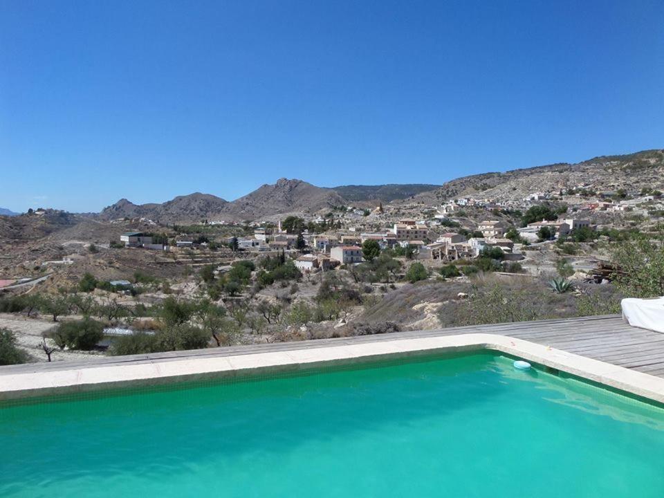 a swimming pool with a view of the mountains at Guest House Guapas in La Garapacha