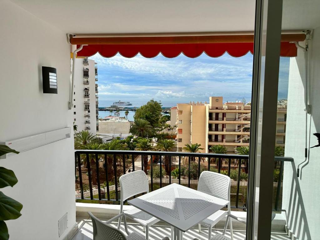 a balcony with a table and chairs and a view at Achacay View Apartment in Los Cristianos