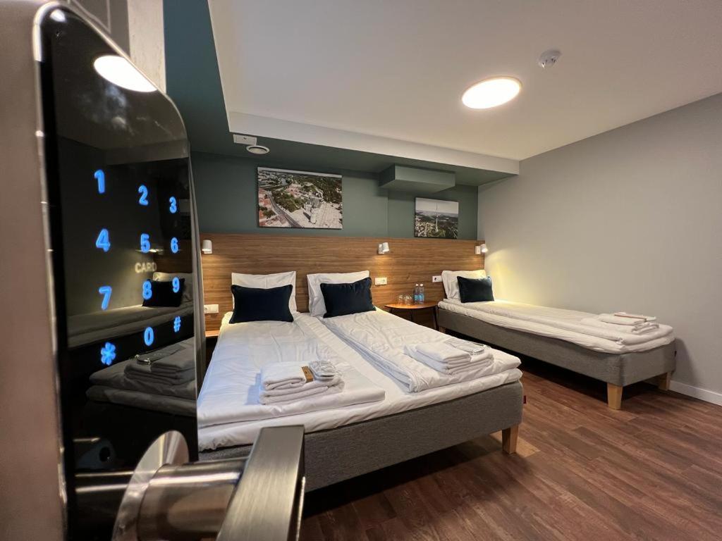 Stay Vilnius Hotel — A bedroom with two beds in a room