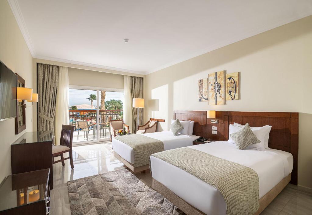 A bed or beds in a room at Sultan Gardens Resort Sharm El Sheikh - Ultra All Inclusive