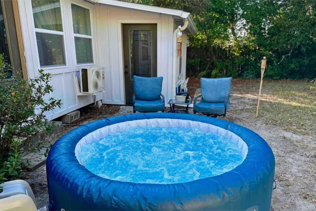 a large hot tub in the backyard of a house at Down By The Bay w Hot Tub, 2 Blocks 2 Beaches, Game Room, Reading Nook, Dog-Friendly, Historic Charm in Panama City