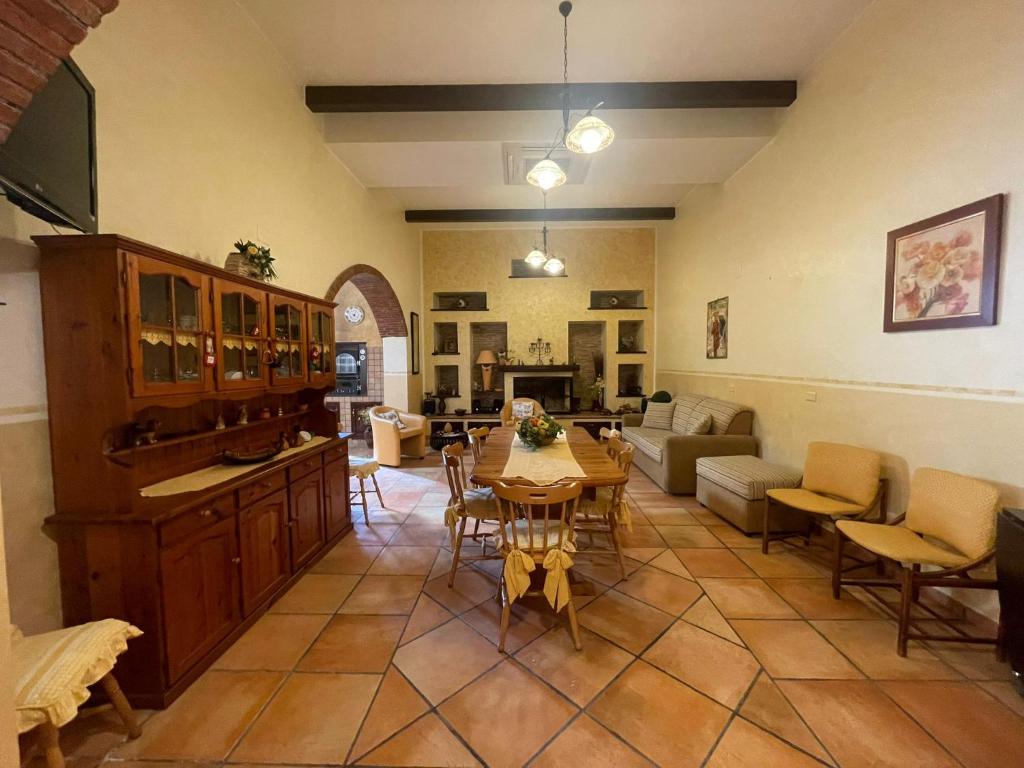 a large living room with a table and chairs at Casa Vacanze Riva Blu in Santa Teresa di Riva