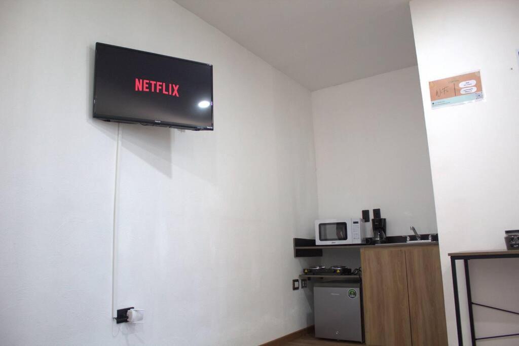 a television on a wall in a room at Departamento Plata Cielito in Jesús María