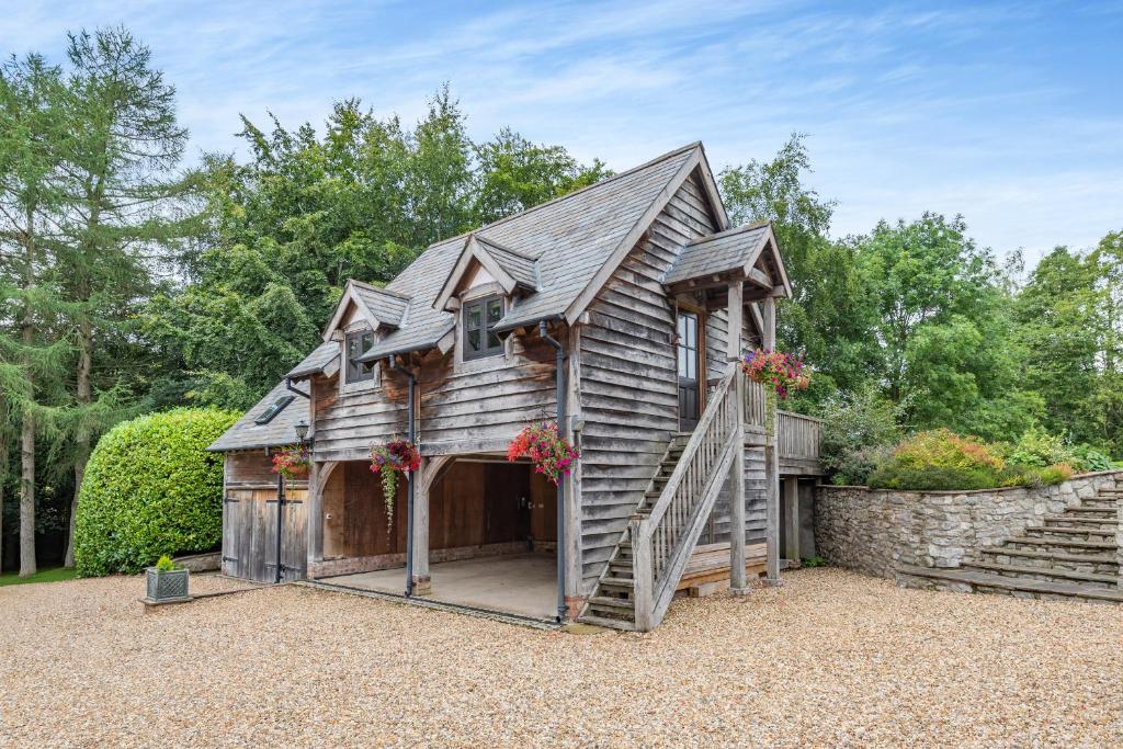 a small wooden house with a large garage at Pultheley Cottage in Montgomery