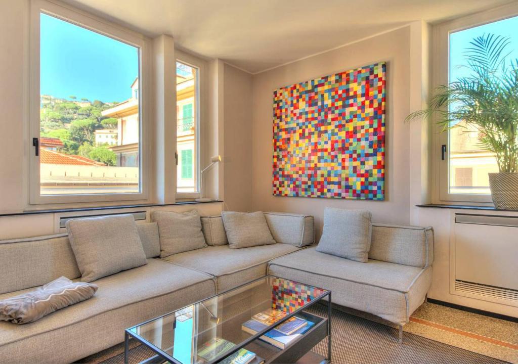 ein Wohnzimmer mit einem Sofa und einem Gemälde in der Unterkunft Livin' Portofino LUX in Santa Margherita Ligure