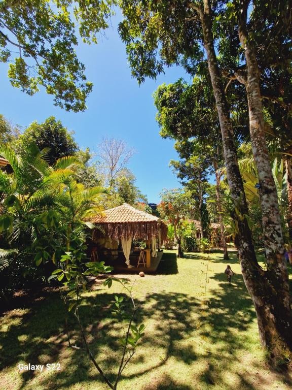 a gazebo in the middle of a park with trees at Mini Casa com Jacuzzi e Piscina in Trancoso