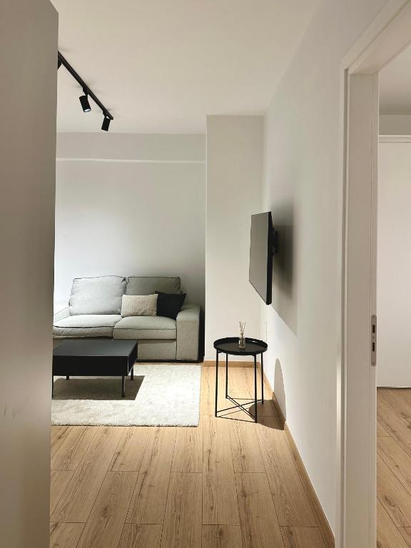 a living room with a couch and a table at City Centre Apartment in Patra