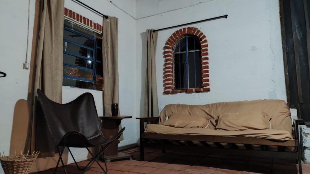 a living room with a couch and a window at Espacio Joseana in Cerro Caqueira