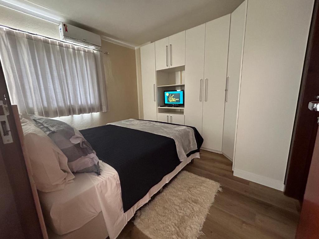 a bedroom with a bed and a tv in it at 1104 - Residence Service in Porto Velho