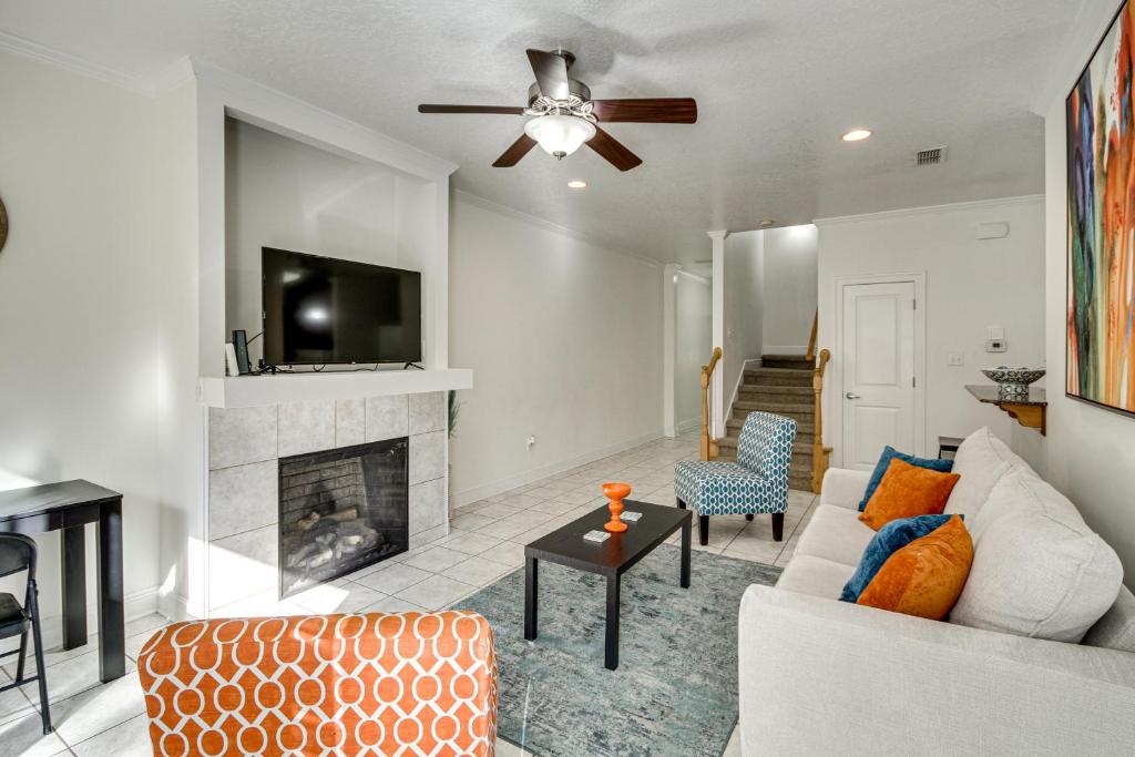 a living room with a couch and a fireplace at Ideally Located Gulfport Condo Less Than 1 Mi to Beach! in Gulfport