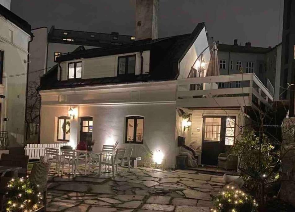 a white house with a patio at night at Unique Experience in Oslo's Heart in Oslo