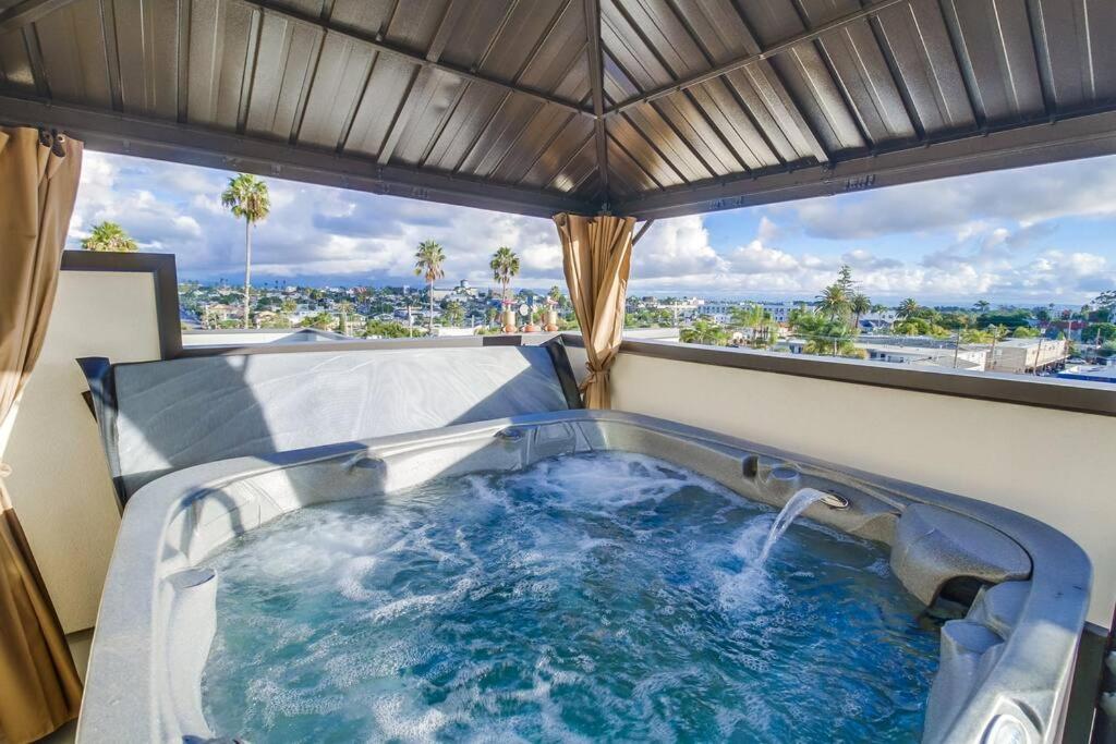 a hot tub in a room with a large window at Park Blvd Paradise 303 king bed With a private Spa in San Diego