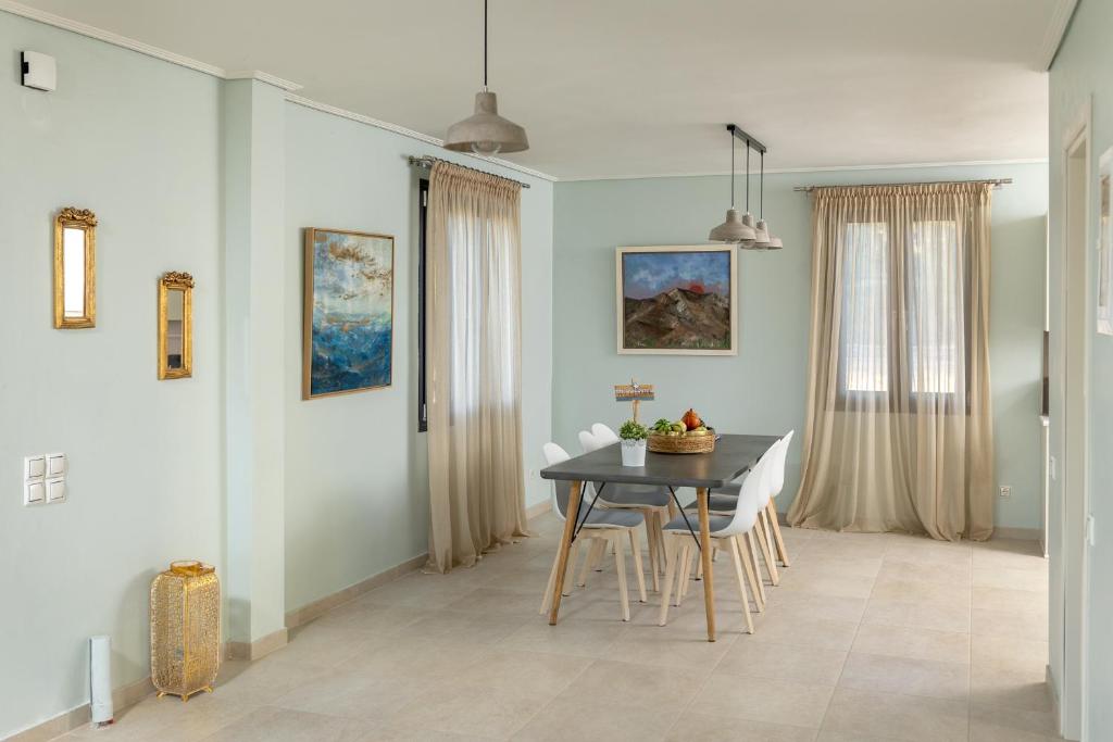 a dining room with a table and chairs at Lampetos Houses Molyvos in Mythimna