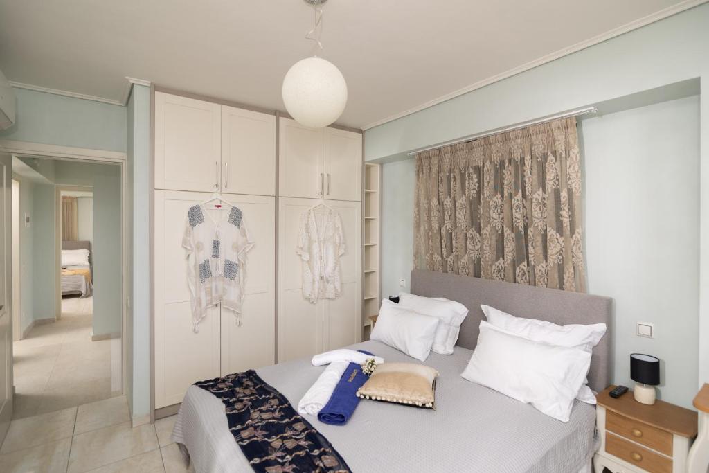 a bedroom with a bed with white sheets and pillows at Lampetos Houses Molyvos in Mythimna