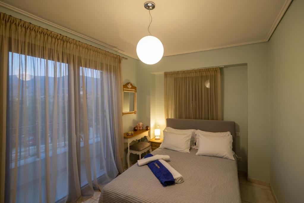 a bedroom with a bed with a suitcase on it at Lampetos Houses Molyvos in Mythimna