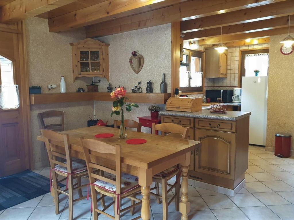 a kitchen with a wooden table with chairs and a refrigerator at Chalet Morzine, 3 pièces, 5 personnes - FR-1-754-77 in Morzine