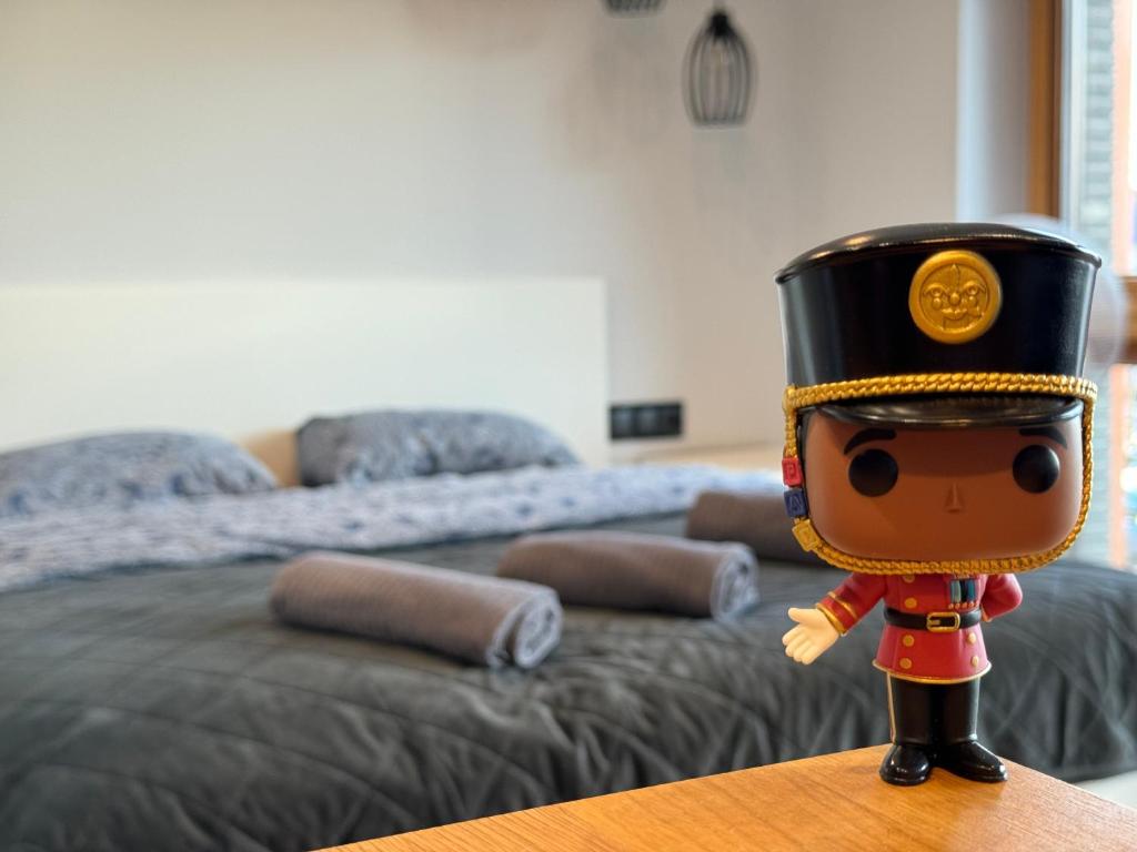 a toy is sitting on a table in front of a bed at Belnea Nadmotławie - Comfy Apartments in Gdańsk