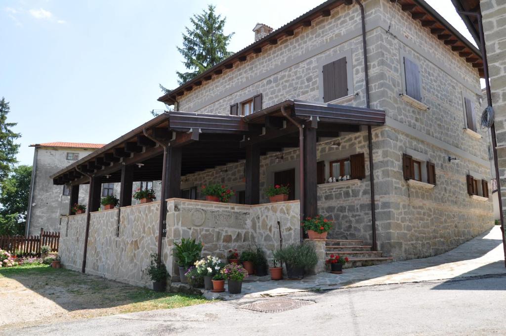 a building with a stone wall with plants on it at Agriturismo Casavecchia in Abetito