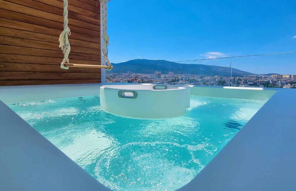 a bath tub sitting in the middle of a swimming pool at One 360 Skyline Athens Penthouses in Athens