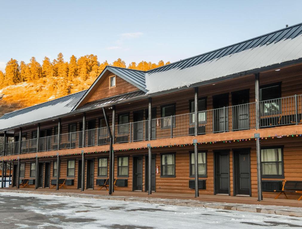 a large wooden building with a metal roof at High Creek Lodge and Cabins in Pagosa Springs