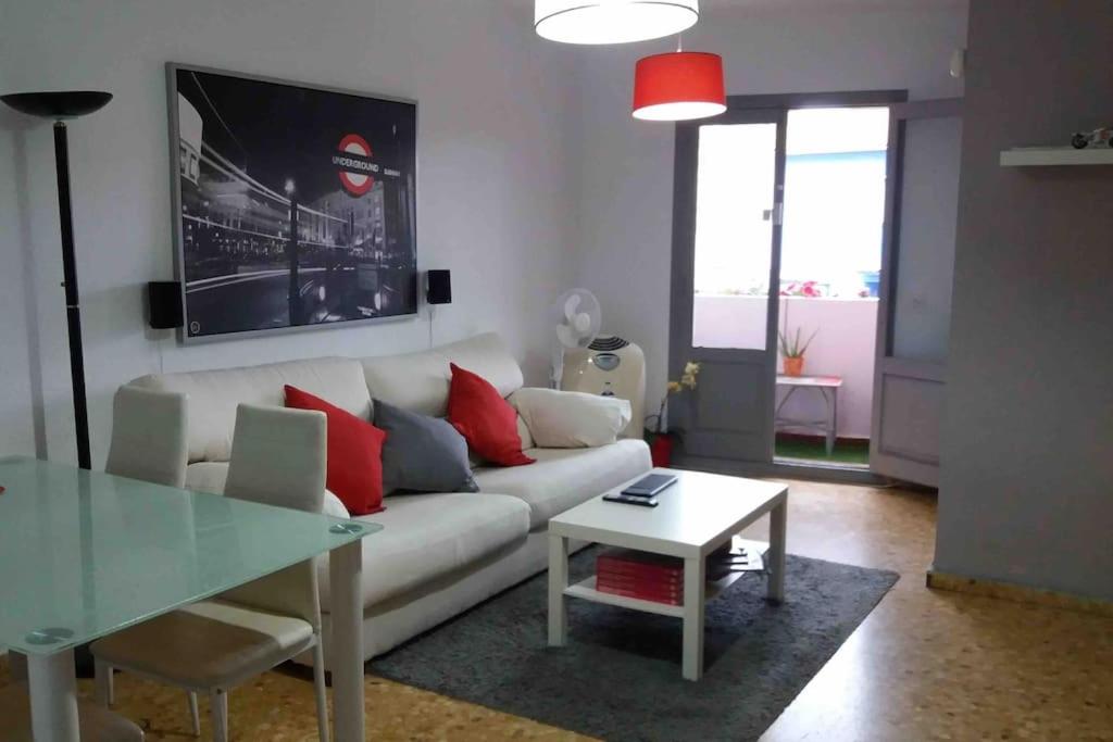a living room with a white couch and a glass table at APARTAMENTO PLAYA URB PRIVADA 2 Habitaciones in Valencia
