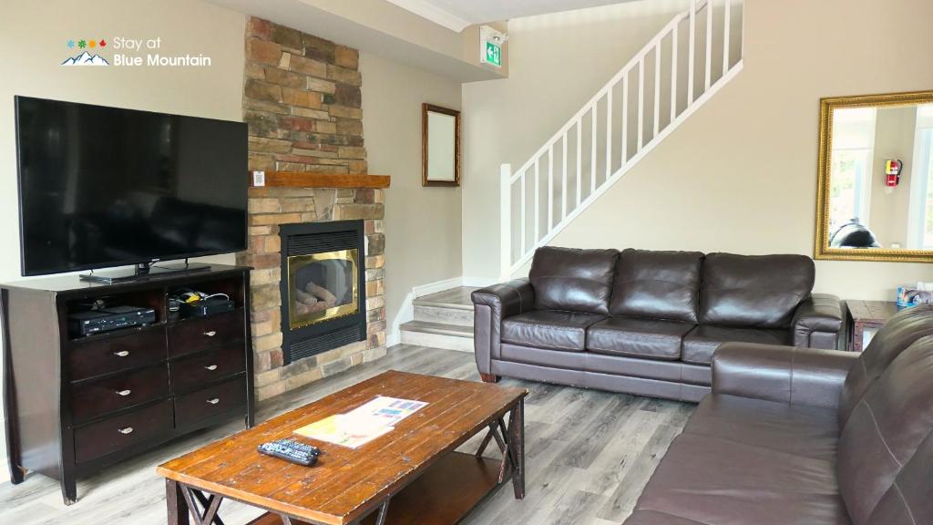 a living room with a couch and a fireplace at 106 Birch View Trail in Blue Mountains