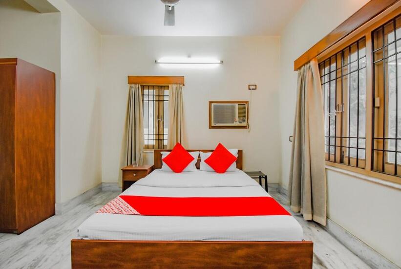 Postel nebo postele na pokoji v ubytování OYO Retro Residency