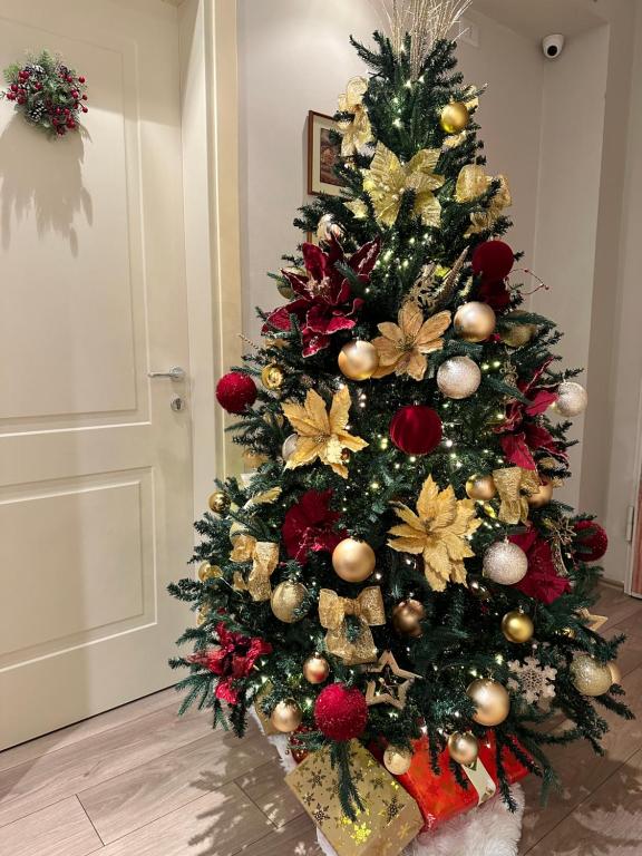 a christmas tree with decorations on it in a room at Home away from Home Apartment in Durrës