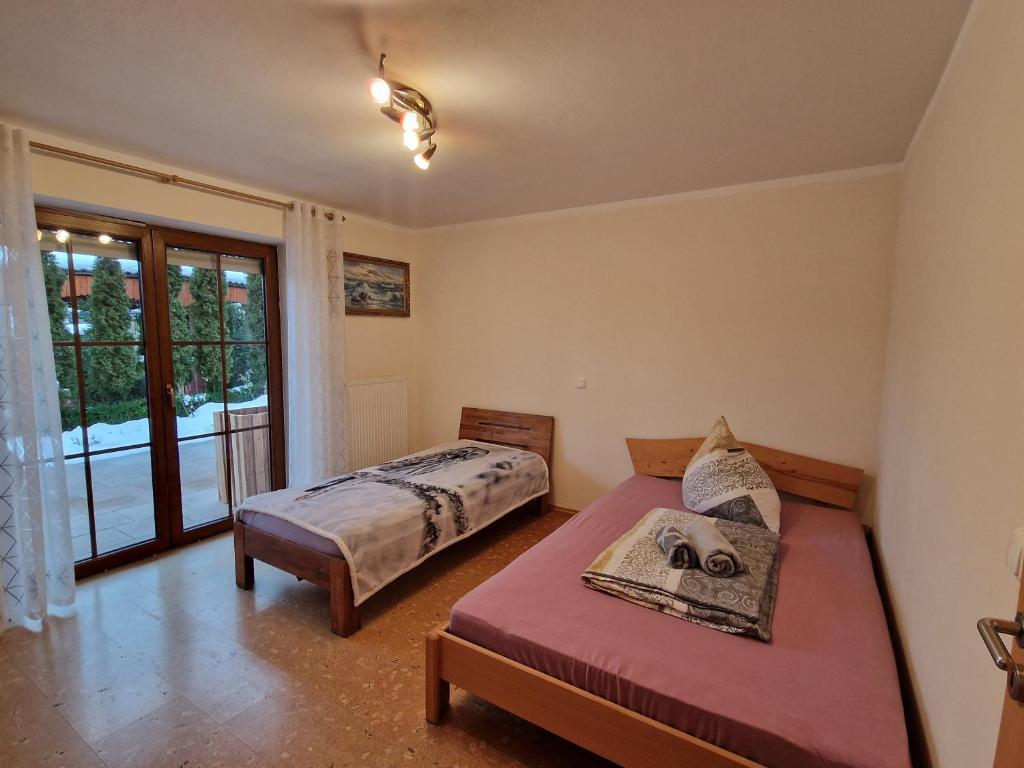 a bedroom with two beds and a large window at Piece of Greece in Neunburg vorm Wald