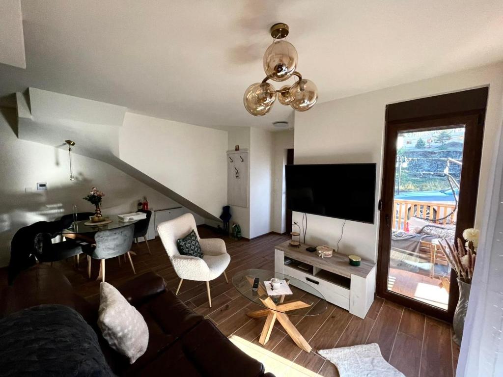 sala de estar con sofá y TV en Golden Gondola Tornik, en Zlatibor