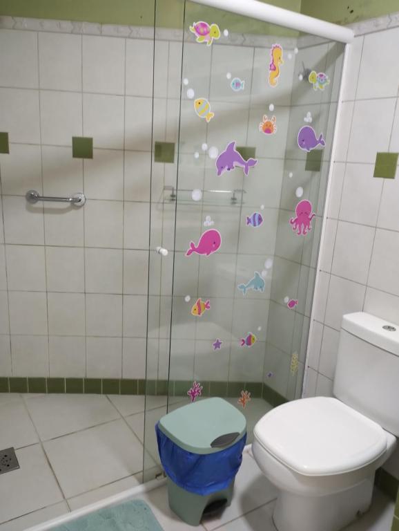 a bathroom with a toilet and a shower at Apartamento na Praia in Torres