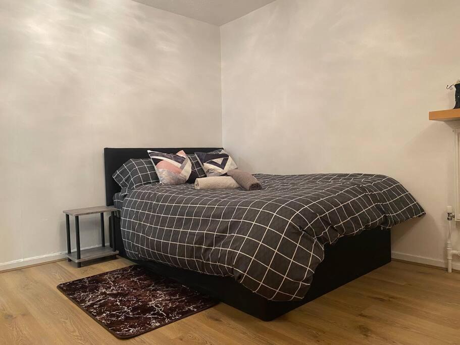 a bedroom with a bed with pillows on it at 2 bedroom flat Camberwell grove in London