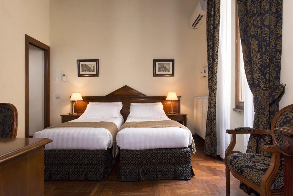 Postel nebo postele na pokoji v ubytování Hotel Teatro Pace