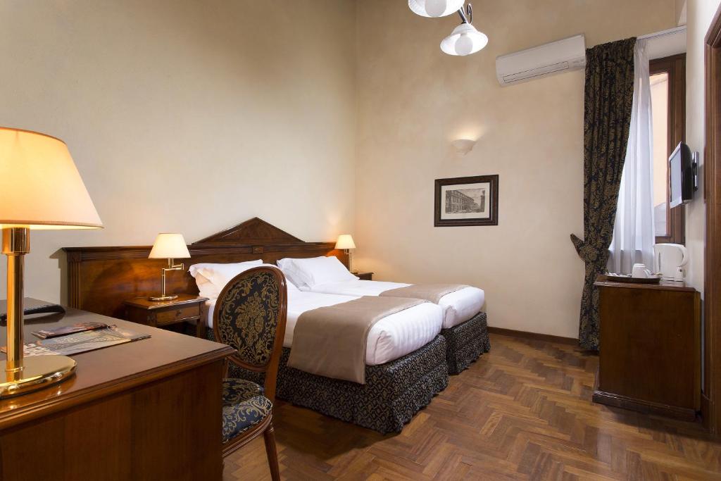 Postel nebo postele na pokoji v ubytování Hotel Teatro Pace