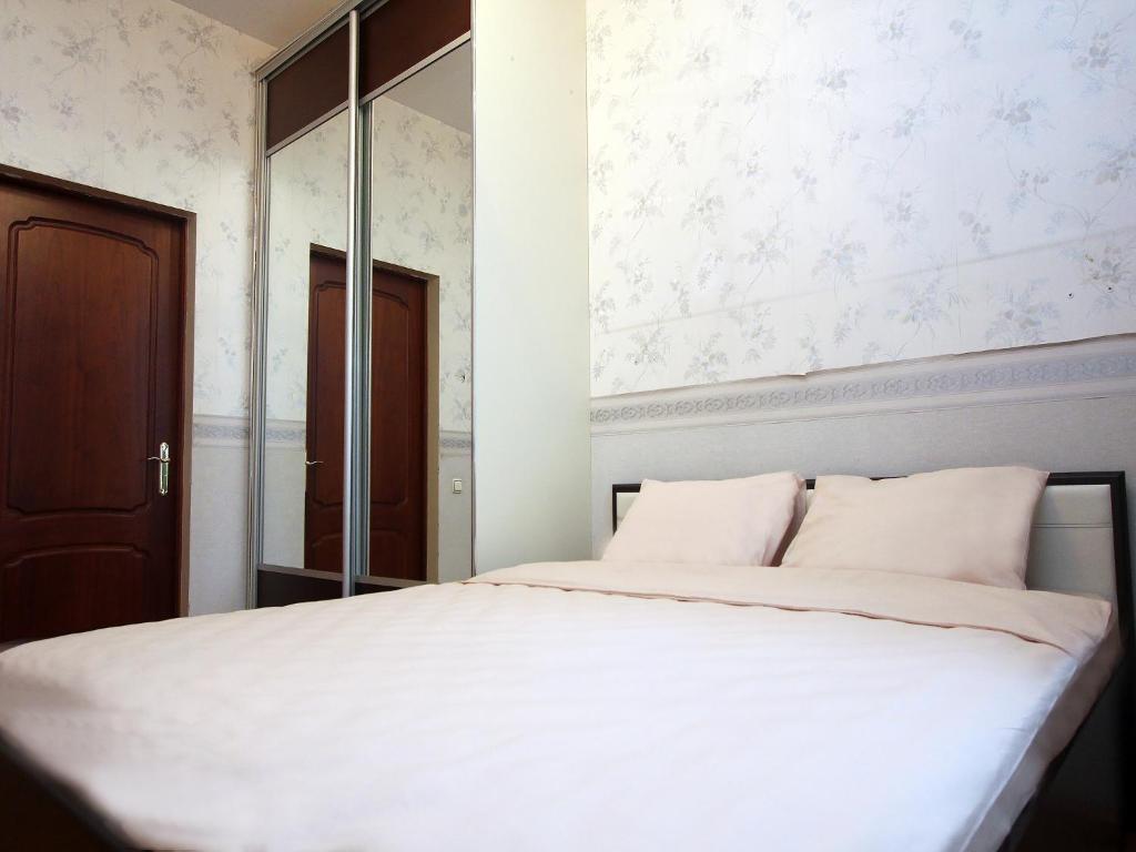 a bedroom with a white bed and a mirror at ApartLux na Ploshadi Pobedy in Moscow