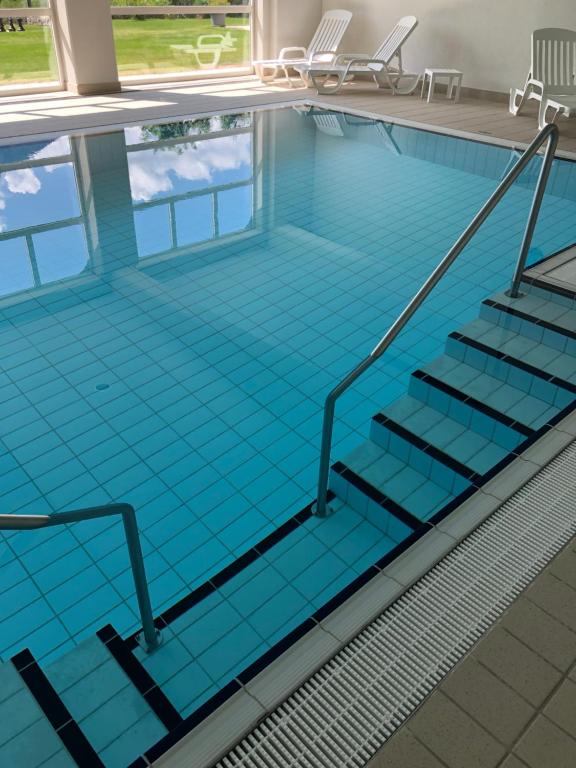 an empty swimming pool with stairs in it at Magnifique Appartement Cosy in Chateau-d'Oex