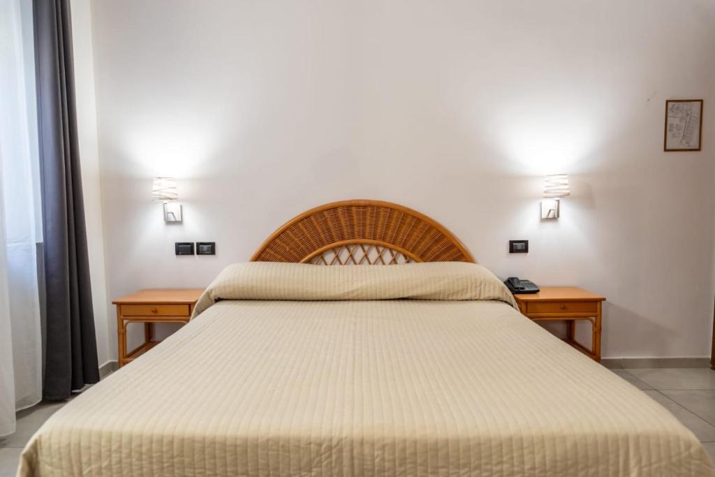 Postel nebo postele na pokoji v ubytování Hotel Corallo
