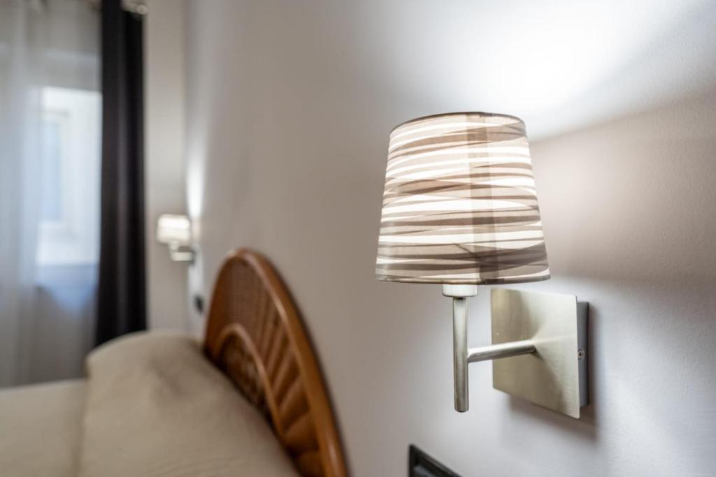 Postel nebo postele na pokoji v ubytování Hotel Corallo