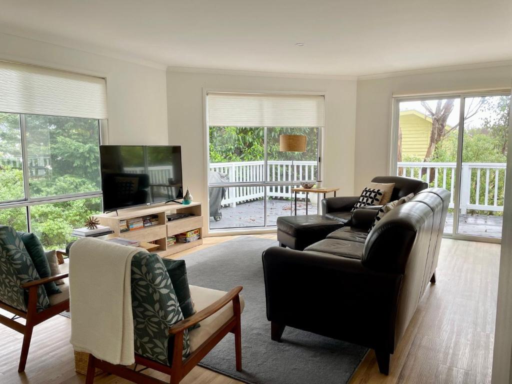 a living room with two couches and a television at Bangalla Inlet Side in Inverloch