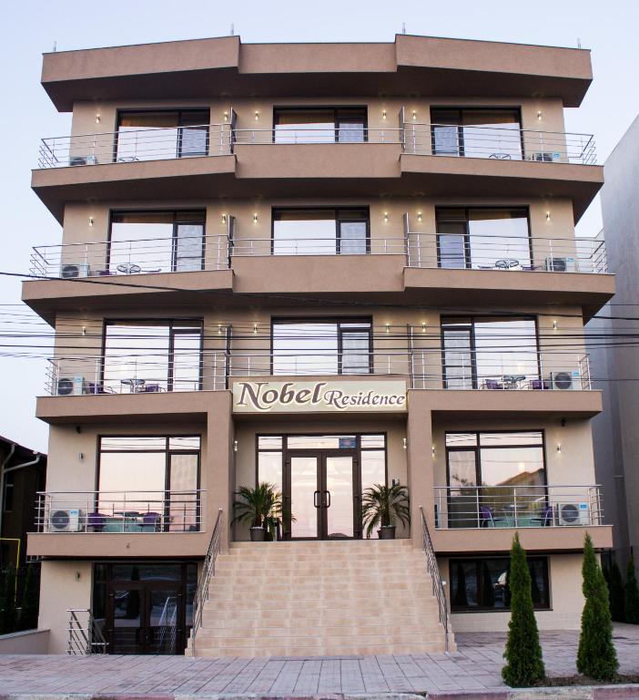 a building with a staircase in front of it at Nobel Residence in Mamaia Sat/Năvodari