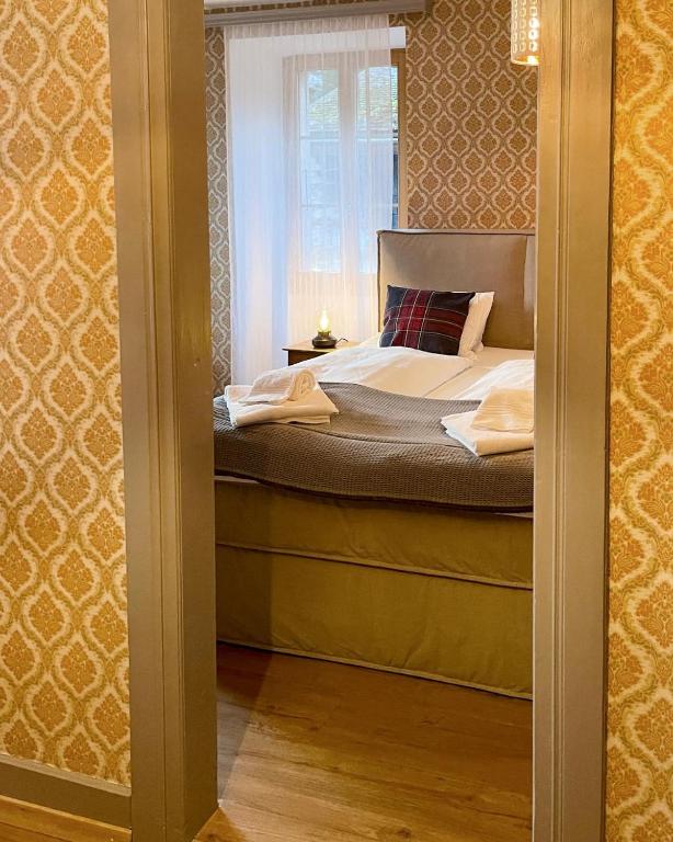 Postel nebo postele na pokoji v ubytování DU GLACIER Boutique & Traditions Hotel