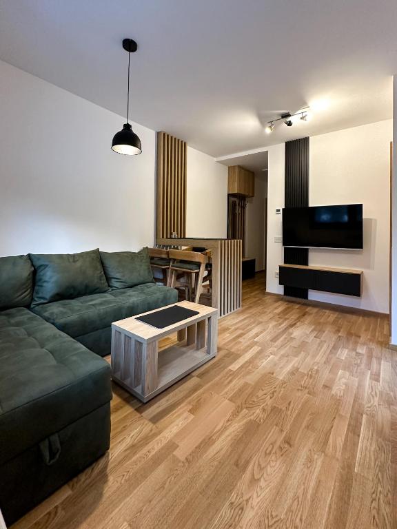 a living room with a couch and a table at Sofija Apartman Zlatibor in Zlatibor