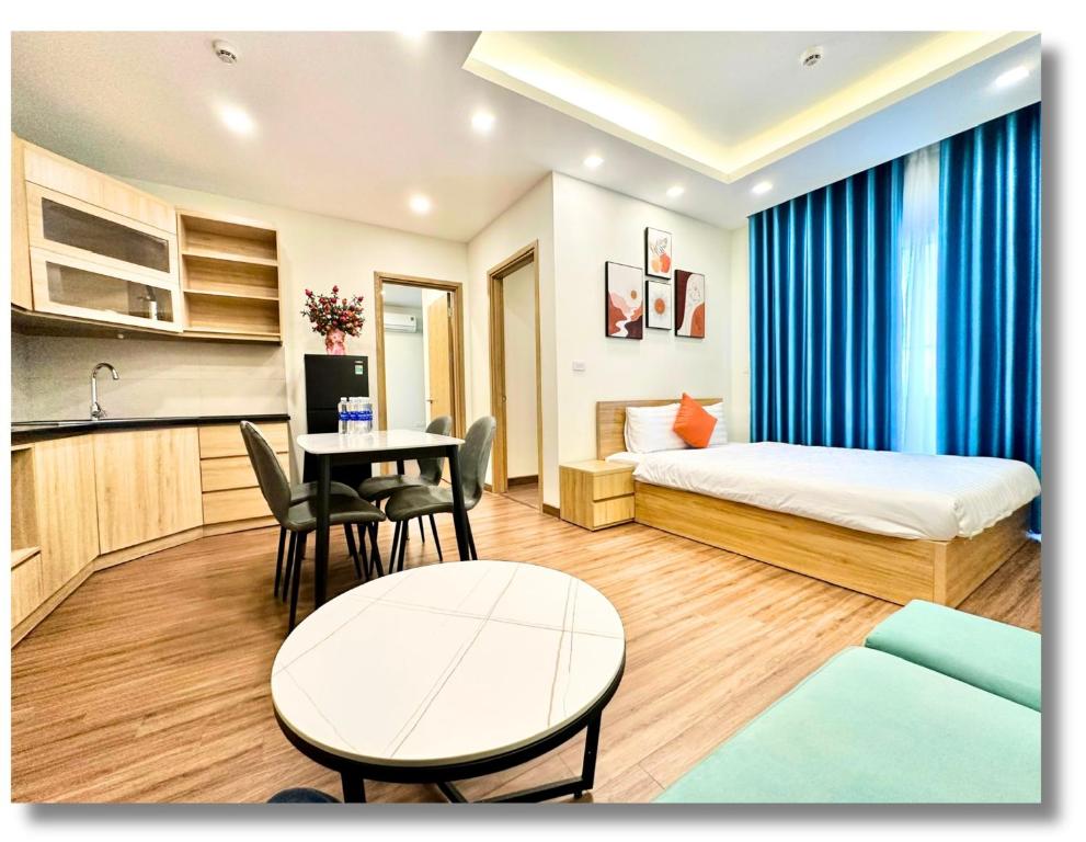 a hotel room with a bed and a table at FLC Luxury Apartment Quy Nhon in Quy Nhon