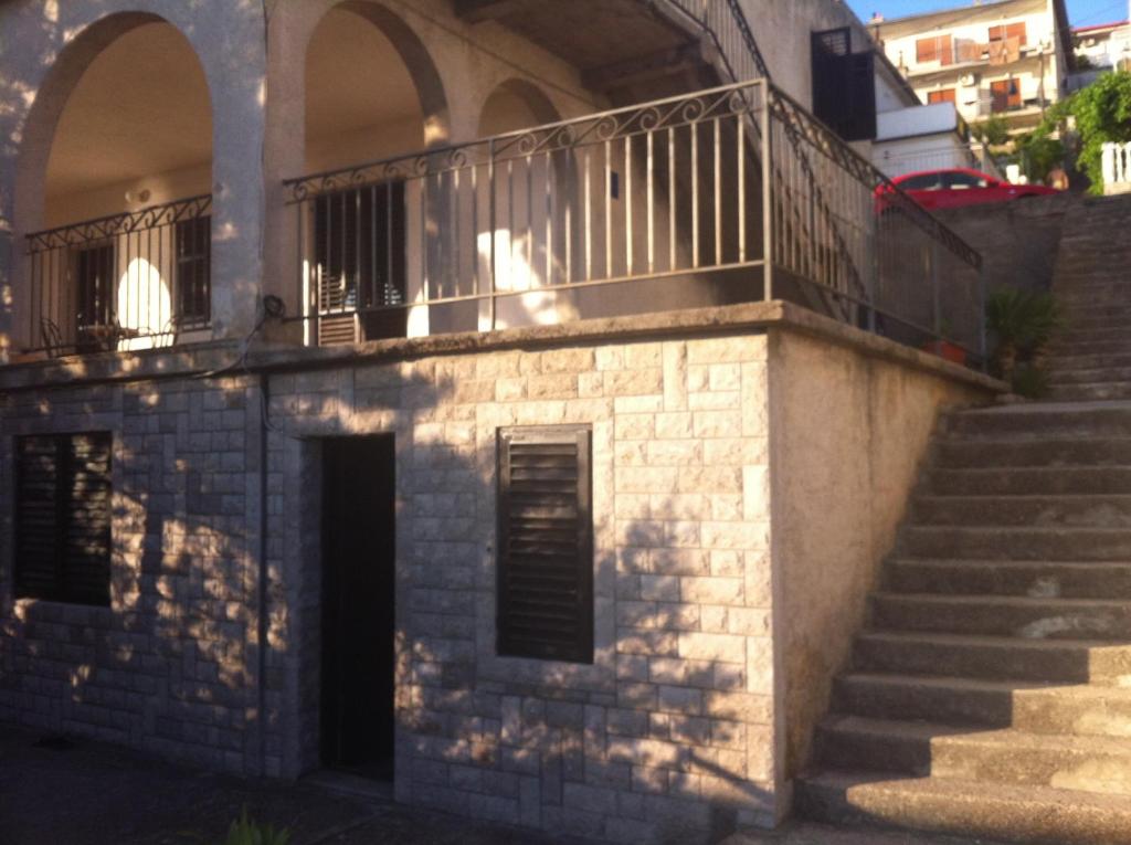 a building with a balcony on top of it at Vlatković in Senj