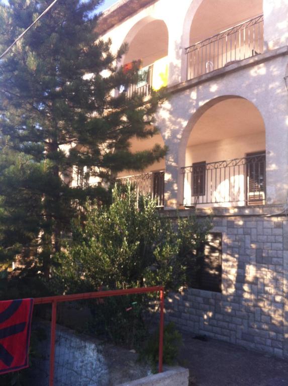 a building with a tree in front of it at Vlatković in Senj
